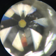 A polished diamond tip seen under a microscope.
